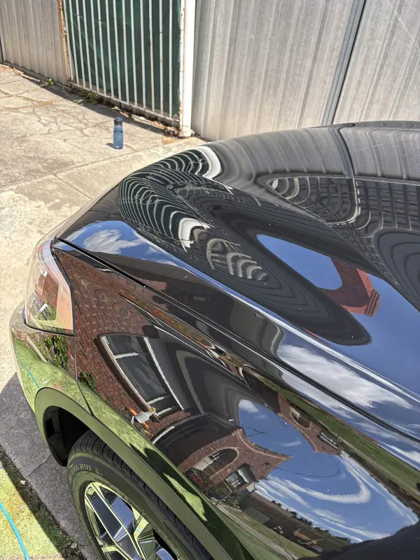 Rear guard of the black X1 reflecting brickwork