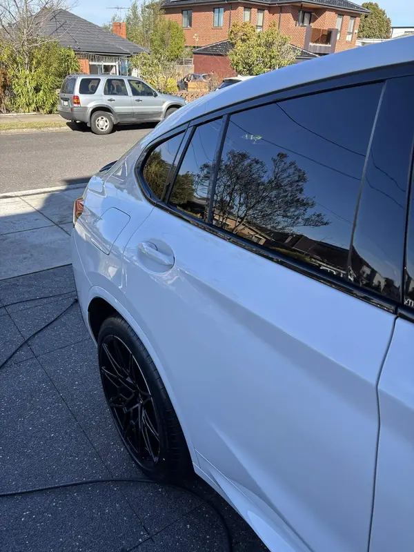 Side windows and rear door of the white X4 M
