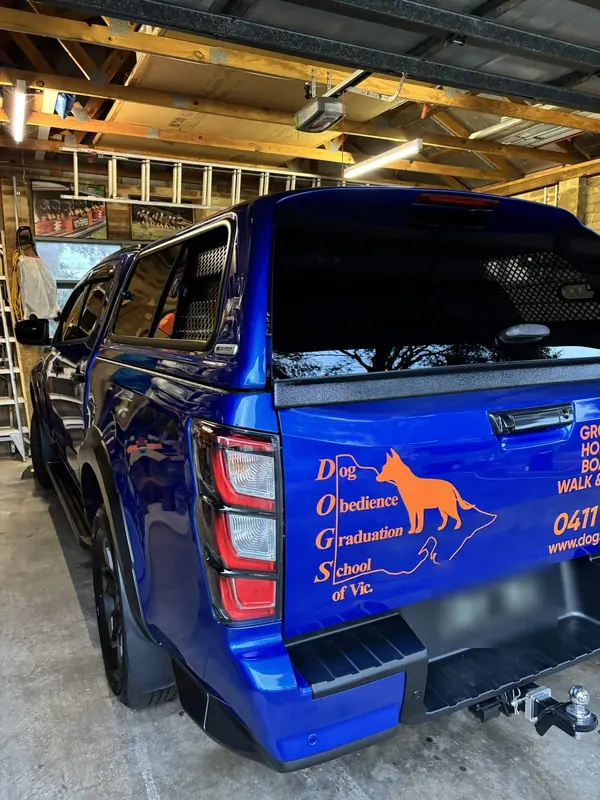 Blue Isuzu D-Max with canopy in a garage