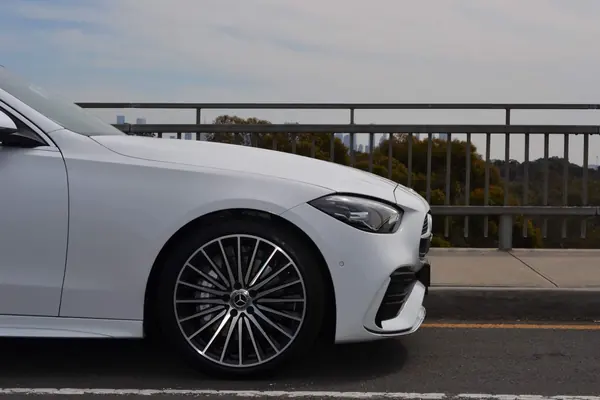 Front of the white C-Class with its wheel in focus