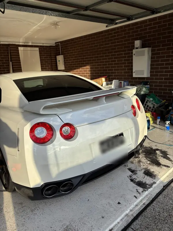 Rear of the white GT-R with its round tail lights