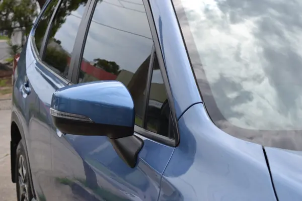 Side windows and mirror of the blue Forester