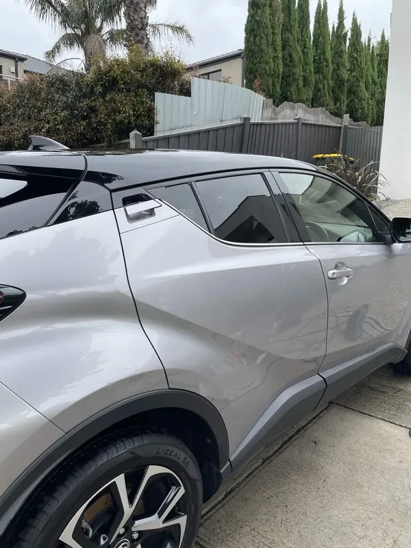 Silver Toyota C-HR side view on a driveway